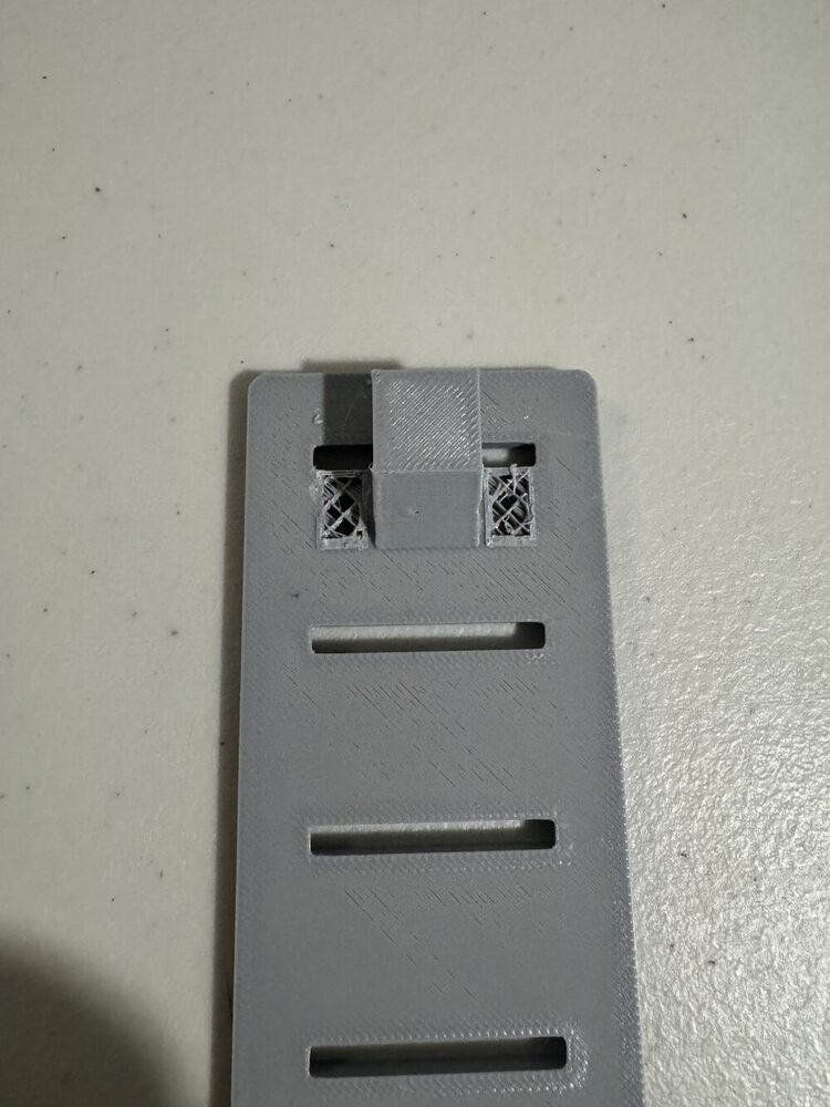 Cover clip with the outer 2 segments removed, center segment remaining