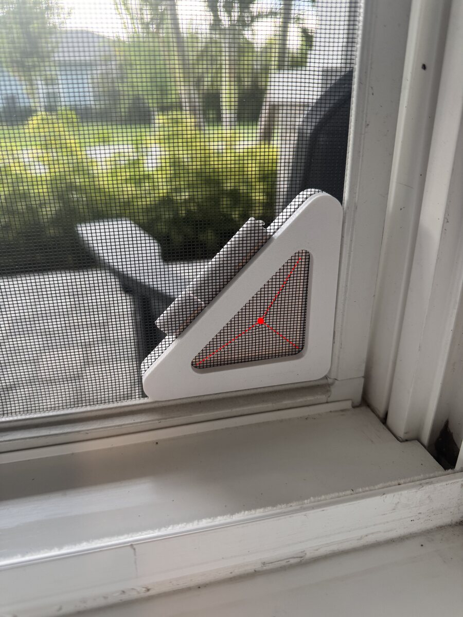 Screen Pass-Thru installed in a lower corner, with red dashed lines showing the three cut slits from each point to the center